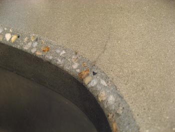 hairline crack in edge of concrete countertop sink hole