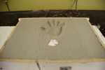 hand print in back of concrete mold