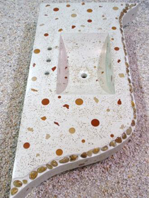 custom concrete sink vanity with river stones embedded in edges and top