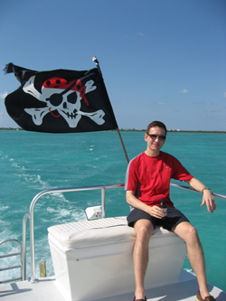 Jeff Girard on boat in Grand Cayman with pirate flag