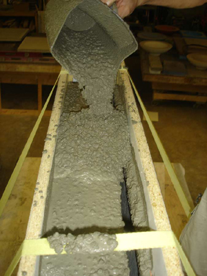 fluid concrete countertop mix being poured into mold