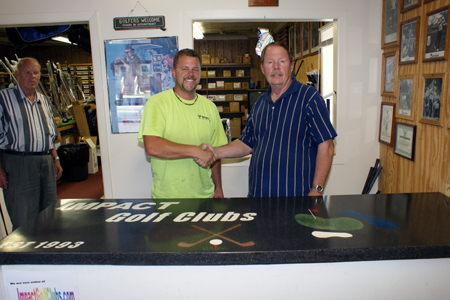 men shaking hands at concrete countertop for Impact golf shop in Minnesota