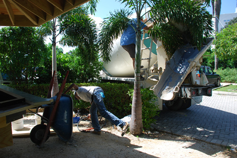 concrete truck delivering concrete in tropical setting