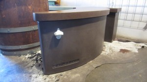 custom concrete bartop with bottle opener embedded