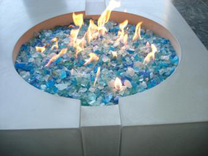 Crater design concrete fire pit in white with light blue fire glass