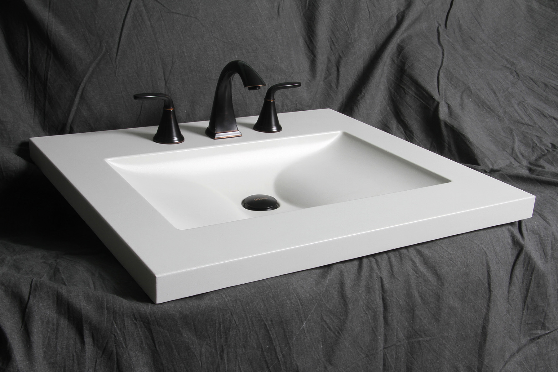 flat white integral concrete sink on gray background