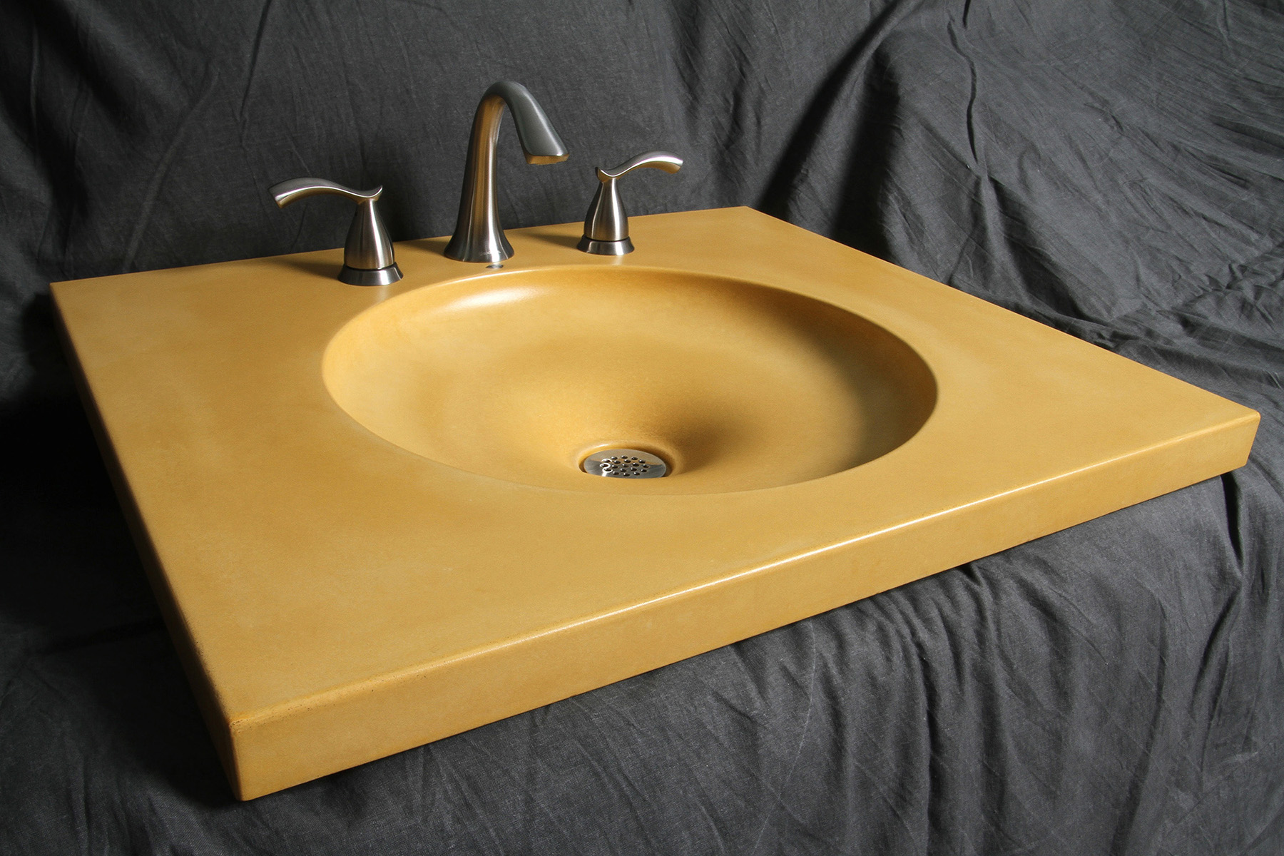 flat orange round integral concrete sink on gray background