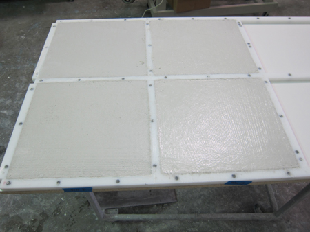 four white GFRC concrete samples in square plastic mold