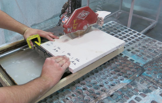 cutting white concrete countertop sample with tile saw