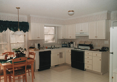 1990s kitchen with white laminate countertops and white cabinets