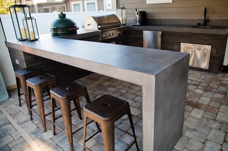 outdoor kitchen with concrete countertop bartop with waterfall edge