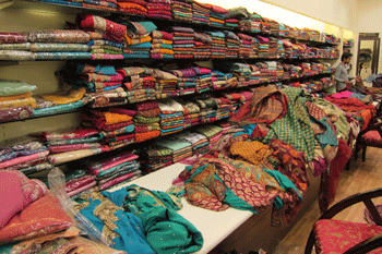 shelves with fabrics in sari shop in India