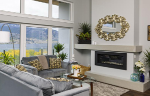 living room with gray sofas and tan concrete fireplace hearth and mantle