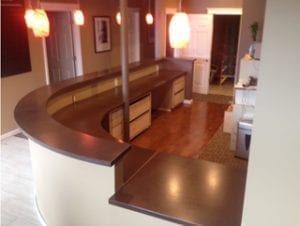 dark brown concrete countertop raised curved bartop by Stoneworks