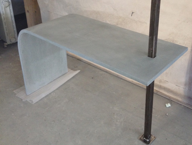 curved concrete table with steel beam by Zen Stoneworks