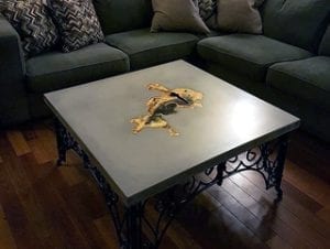 concrete coffee table with embedded wood knot by David Dick