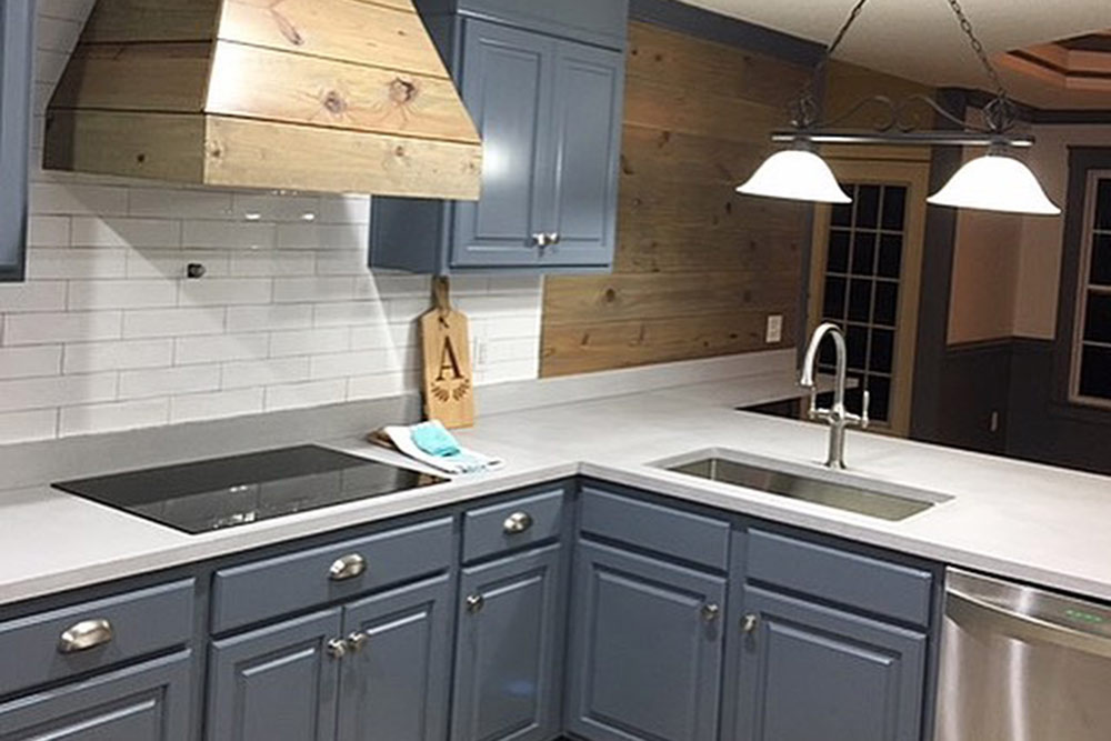 pale gray concrete countertop on blue cabinets in kitchen