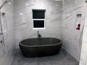 concrete tub and marble tile by Diamond Finish Concrete