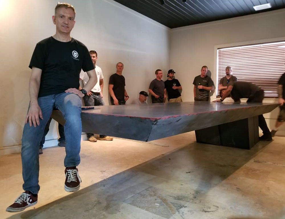 Jeff Girard sitting on cantilevered concrete table