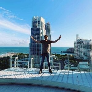 Caleb Lawson standing on concrete couch sofa base on high rise rooftop Florida