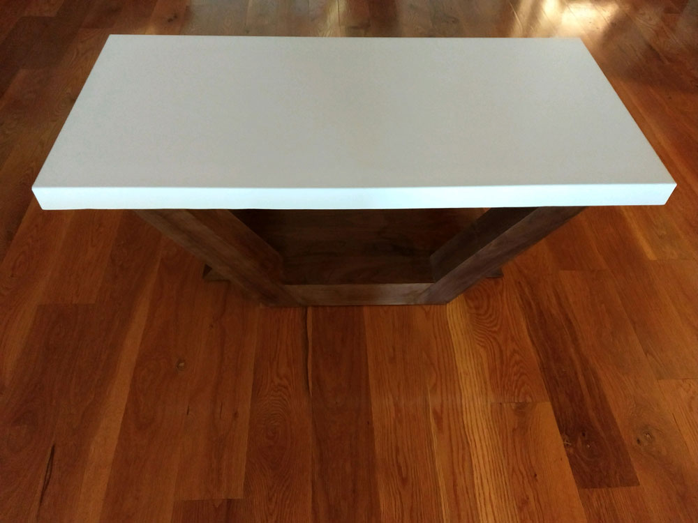 coffee table with concrete top and angled wood base