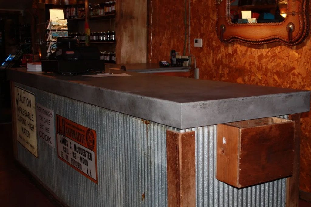 Restaurant concrete countertop in natural gray with black accents. 4 1/2 inch drop edge.