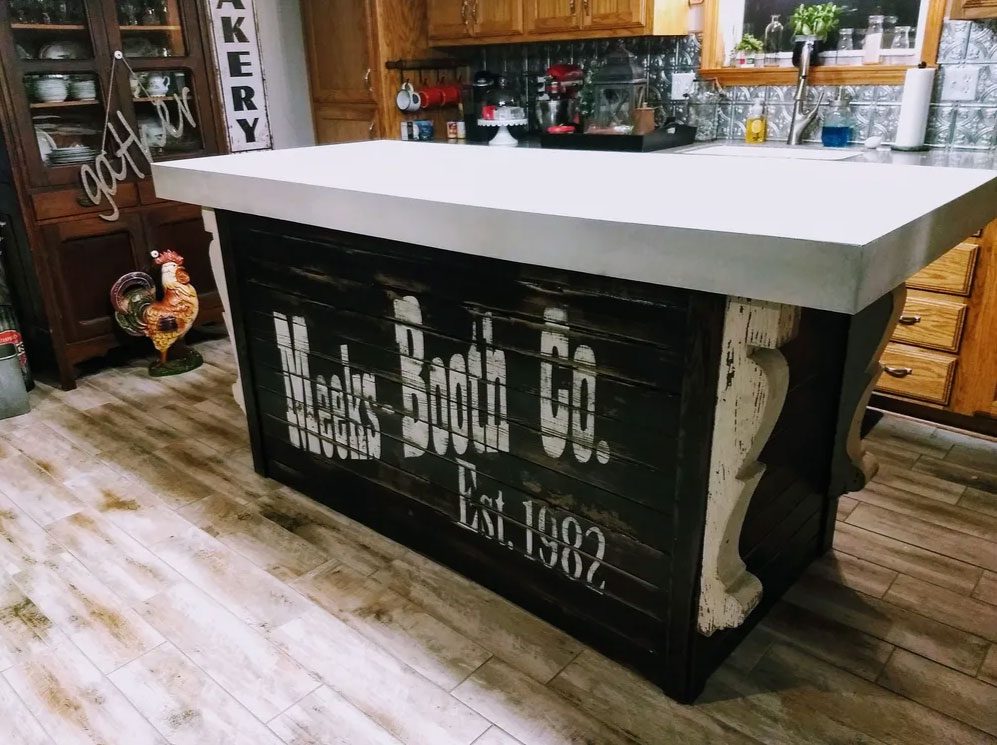 Kitchen island concrete top with 4-inch drop sides in blended white and bisque colors.