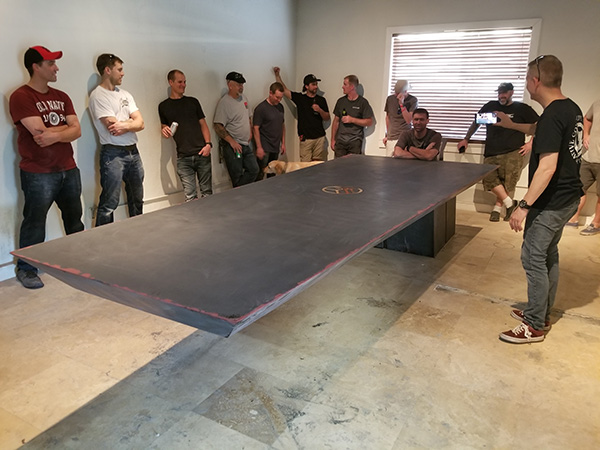 sitting at end of 11 foot cantilevered concrete table