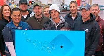 people holding bright blue concrete sink