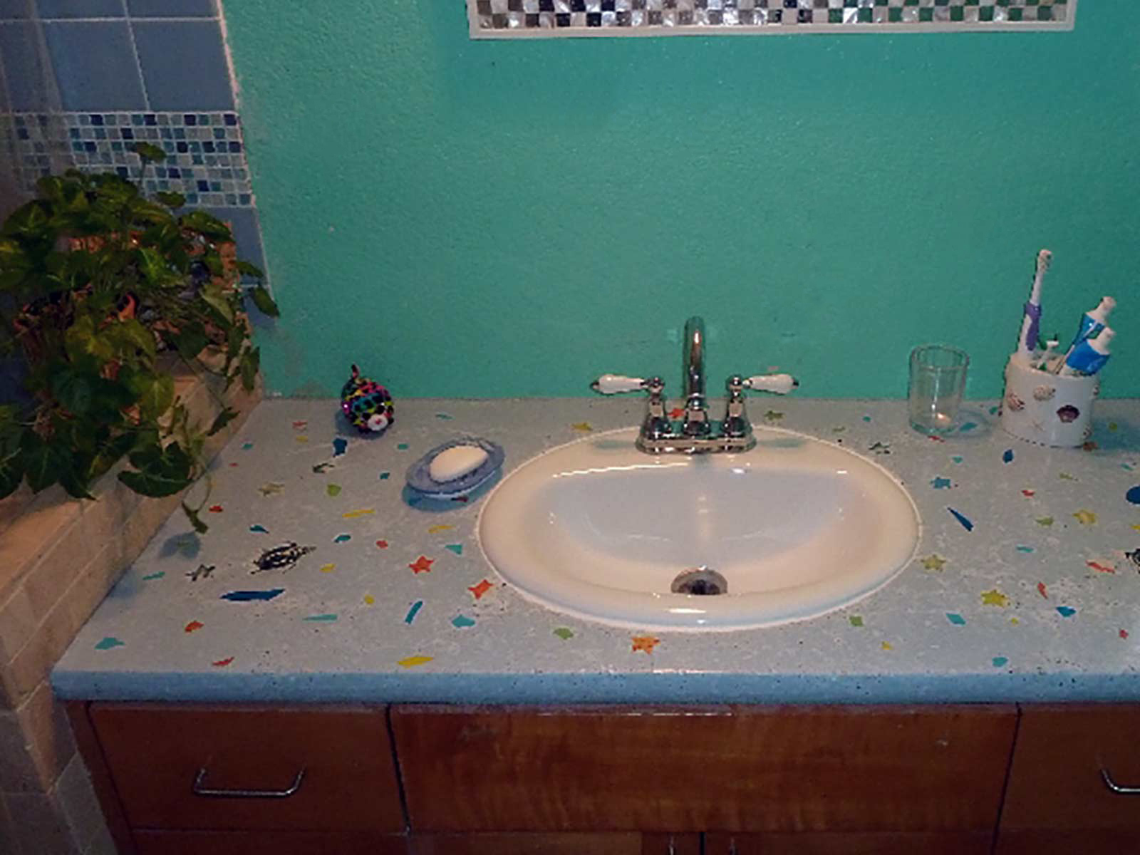 DIY concrete countertop in bathroom with colored glass