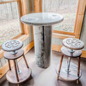 textured concrete table with metal gears by Artisan Elements Georgia