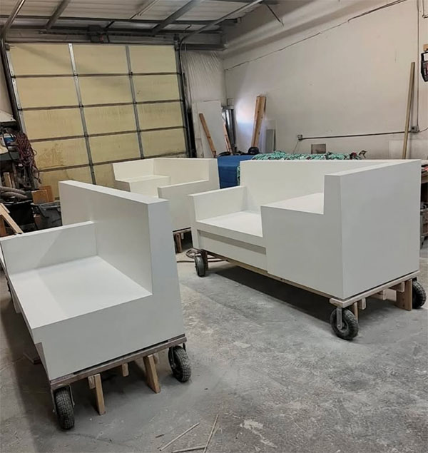 White precast concrete sofa sections on wheeled dollies in the Batch & Trowel shop