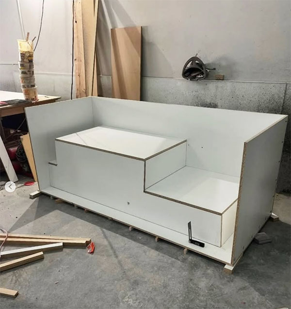 Melamine mold for a precast concrete sofa section with stepped seat and armrest